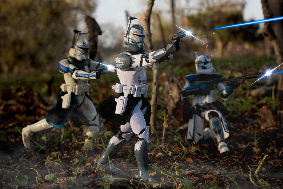  Photo of 3 clone trooper figures from Star Wars shooting blasters.
