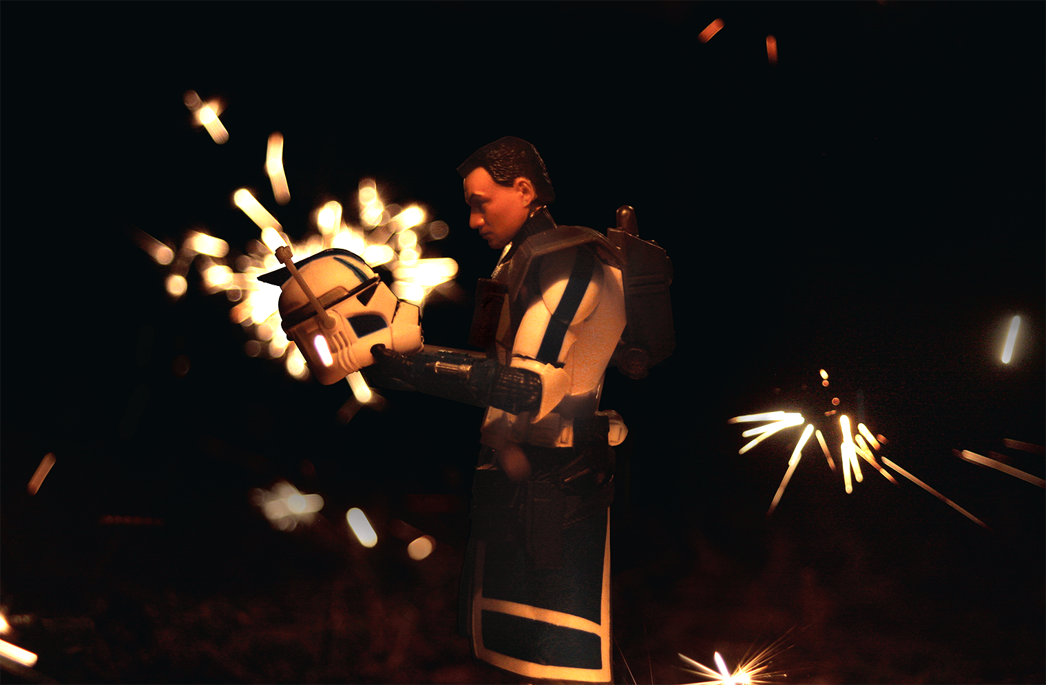  Photo of figure of clone trooper from Star Wars holding their helmet and staring at it with explosions going off in the background.